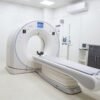 High-resolution image of a modern, clean MRI scanner room in a hospital facility.