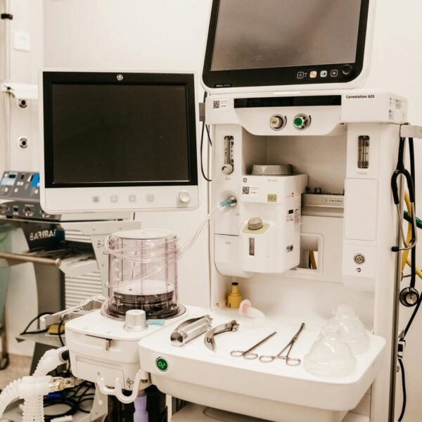 High-tech medical equipment setup in a hospital room, featuring monitors and surgical tools.